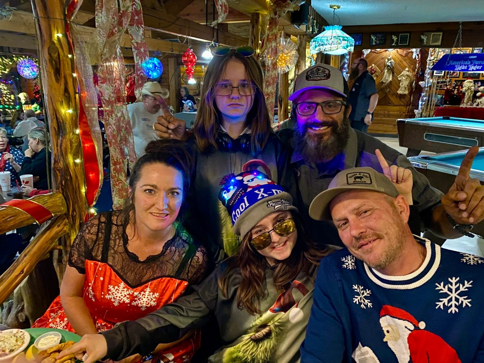 Five South Texas Stampede team members gathered together in holiday clothing
